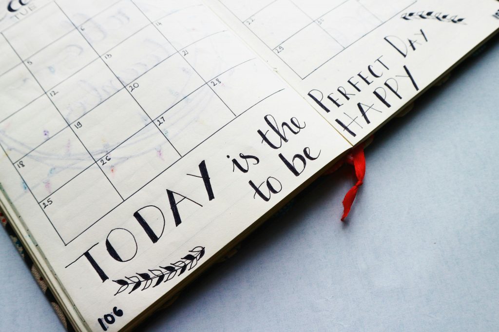 pexels photo 636246 636246 Open planner with handwritten quotes and calendar layout, promoting positivity and organization.